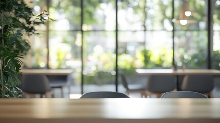 Poster - A serene indoor space with greenery and tables, ideal for meetings or relaxation.