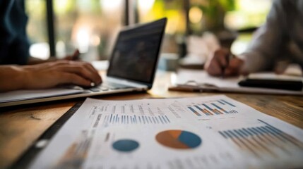 Poster - A workspace with graphs and charts, indicating analysis and collaboration.