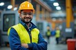 © velikiyzayats - Confident Industrial Worker in Hard Hat and Safety Vest Posing in Factory Setting, Perfect for Safety and Workplace Training Materials