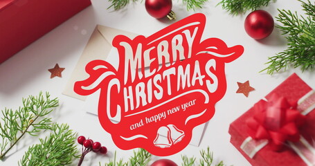 Wall Mural - Image of merry christmas over envelopes and decorations on white surface