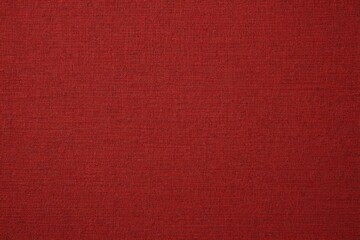 a close up of a red fabric textured background with a slight pattern