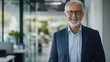 © WS Studio 1985 - Happy Mid-Aged Businessman Standing in Modern Office Environment