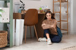 © Pixel-Shot - Tired female student sitting on floor at home
