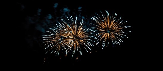 Aufkleber - Colorful fireworks display in the night sky showcasing vibrant bluish tones with sparkling effects and dramatic lighting contrasts