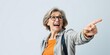 © Chalermrach - Excited and surprised middle-aged woman pointing to side and upwards with copy space, upwards, joyful