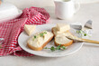© Pixel-Shot - Plate with fresh bread, triangles of tasty processed cheese and micro green on light table