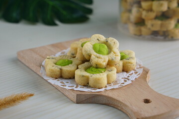 Indonesian mint cookies photographed on a white table with a wooden theme in an indoor studio