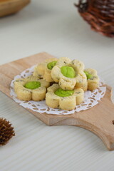 Wall Mural - Indonesian mint cookies photographed on a white table with a wooden theme in an indoor studio