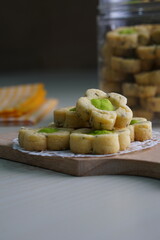 Wall Mural - Indonesian mint cookies photographed on a white table with a wooden theme in an indoor studio