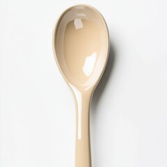 Poster - A sleek, beige kitchen spoon against a white background, showcasing a modern and minimalist design.