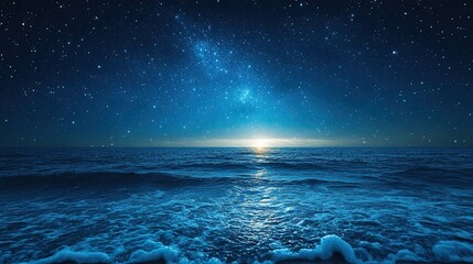 Starry night sky in blue hues above a tranquil ocean scene with abundant copy space.