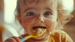 © catocala - Close-up view of toddler enjoying a messy meal with a spoon in a cozy kitchen setting