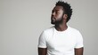 © Максим Фокин - Man in a white T-shirt gazing sideways, gray background