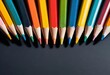 © Kiryakova Anna - Close-up of colorful sharpened pencils arranged in a row on a dark background.