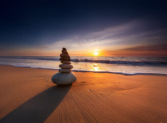 Aufkleber - Serene sunset over ocean beach, a carefully balanced rock cairn casts a long shadow on the sand.  The tranquil scene evokes peace and balance.