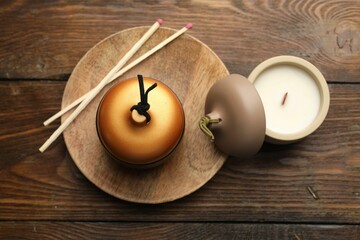 Wall Mural - Soy candles and matches on wooden table, flat lay