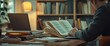 © EFA - A person studying with books and a laptop on a wooden desk in a cozy setting.