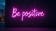 © Sofia - Neon scripture “Be positive” on the brick wall in the city.