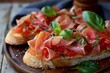 © juliars - Tasty bruschetta with tomatoes, prosciutto, basil and salt on wooden tray, typical italian appetizer