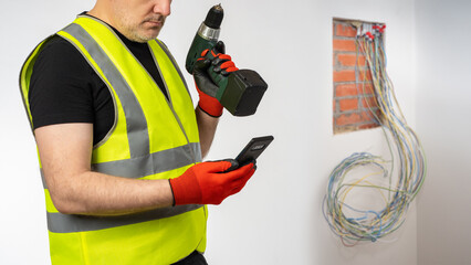 Poster - phone and screwdriver in hands electrician. man electrical equipment repairman. place for power pane