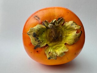 ripe persimmon fruit on a white isolated background