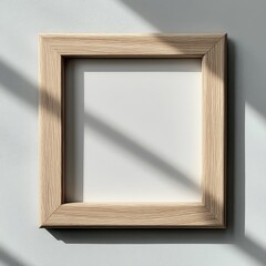 Poster - Empty Wooden Frame Casting Shadows on a Light Gray Wall in a Bright Indoor Setting During Daylight Hours