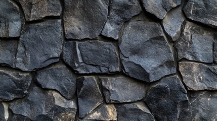 Poster - Textured dark stone wall surface with rough patterns creating a seamless background suitable for various design applications