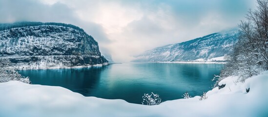 Poster - Panoramic winter river landscape showcasing serene waters and snow-capped mountains ideal for travel and nature-themed projects