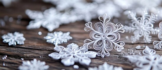 Aufkleber - Beautifully crafted paper snowflakes in quilling technique displayed on a rustic wooden surface creating a festive winter atmosphere.