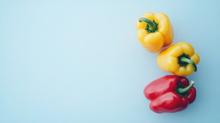Aufkleber - Vivid assortment of mini red and yellow bell peppers on a light blue background showcasing fresh vegetables and healthy eating concepts