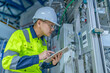 © reewungjunerr - Asian electric engineer holding clipboard for checking and monitoring the electrical system in the control room,Technician thailand people working