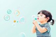 © Withun - Happy Sunday morning concept. A joyful child blowing bubbles, capturing pure childhood delight.