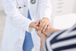 © New Africa - Healthcare worker supporting patient in hospital, closeup