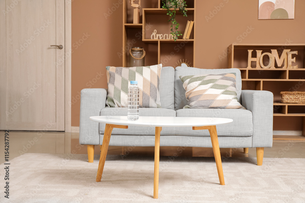Bottle of water on table in living room interior