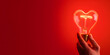 © Ekaterina - A vibrant red heart shaped light bulb glowing brightly in a hand, set against a deep red background, symbolizing love and passion