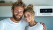 © Dulemegapixel - A playful couple smiling in a bright white kitchen, showcasing a moment of togetherness and happiness, dressed casually, in a fresh and airy atmosphere.