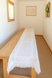 © Maxim Borbut - Design a Scandinavian-inspired living room with a mock-up poster map, a stylish wooden bench, a coffee table, a vase of flowers, and elegant accessories. The walls are painted a beige color.