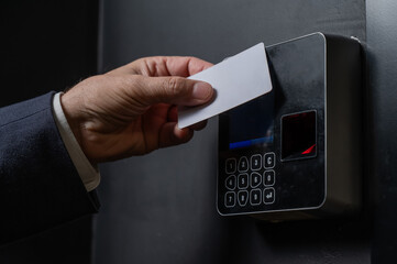 a man opens the door with a card. modern electronic lock. keyless entry