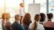 © antusher - Business presentation in a sunlit room with diverse seated audience