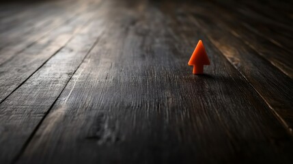 Poster - Close-up of a glowing orange arrow on a black background, representing futuristic growth and advancement with abstract digital lines enhancing the composition