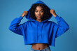© Attala Rizky - A cute teenage girl wearing a blue crop hoodie is grimacing.