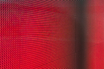 Wall Mural - close-up photo of video wall screen displaying red color with grid layout of pixels for digital pane