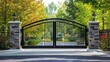 © pook - Sleek front gate with a curved top, flanked by modern stone columns and a vibrant park background.