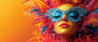 © Helena GARCIA - Primer plano de la cara de una mujer joven con gafas turquesas posando con maquillaje colorido y tocado de plumas rojas, amarillas y naranjas sobre fondo naranja. Concepto fondos carnavales