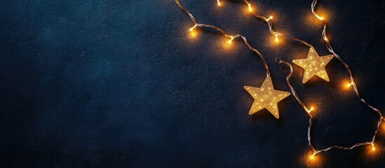 Poster - Star shaped light garlands creating a festive atmosphere with copy space on a dark background overhead flat lay view