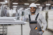 © anatoliycherkas - Factory worker showing thumbs up near aluminum window profiles