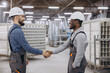 © anatoliycherkas - Factory workers shaking hands after finishing window and door production