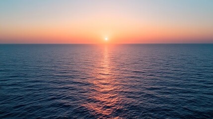Wall Mural - sunrise over calm ocean waves creating vibrant colors in the sky during early morning hours