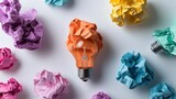 A vibrant image featuring a light bulb made of crumpled paper amidst colorful paper scraps, symbolizing creativity and innovative ideas.