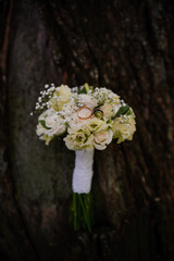 Wall Mural - Elegant Wedding Bouquet with Rings Against Textured Bark